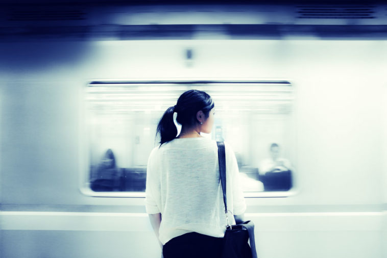Woman watching passing train